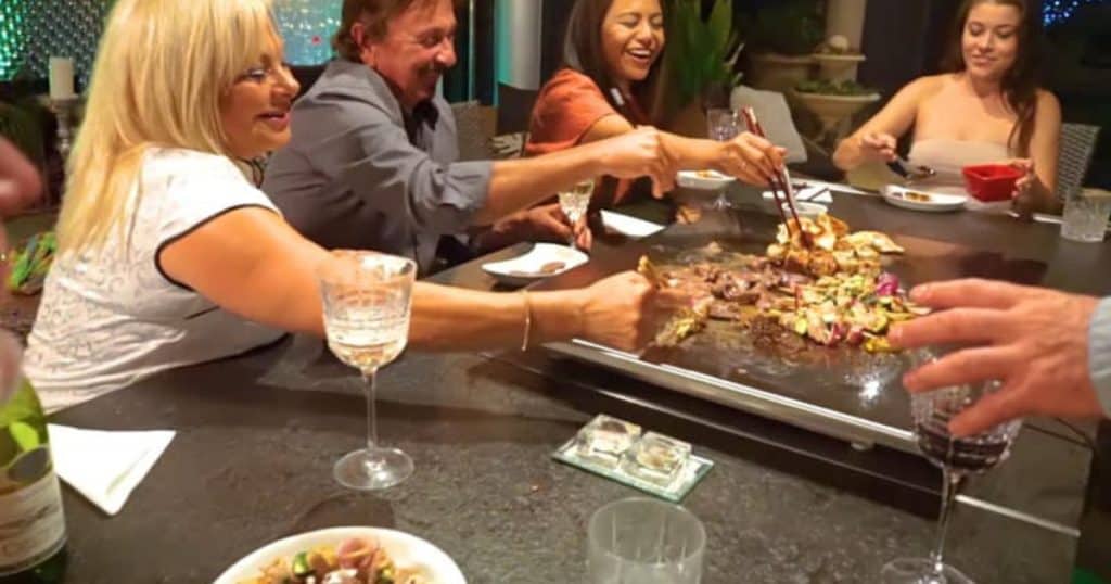 A group of friends having teppanyaki at a bbq grill